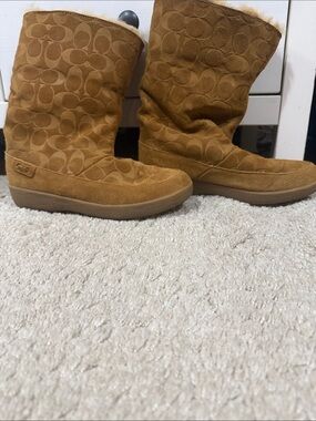 Coach suede boot with embossed signature pattern. Soft tan suede upper. Platform